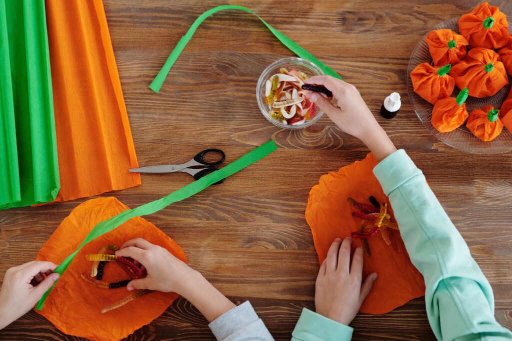 Halloween crafts creating paperpumpkins with candy inside
